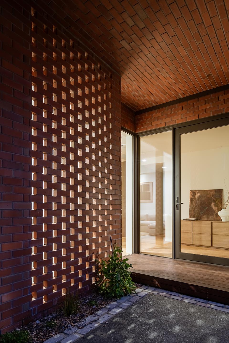 Bryndwr II entrance with perforated brick screening, brick soffit and full-height glazing opening into the interior.